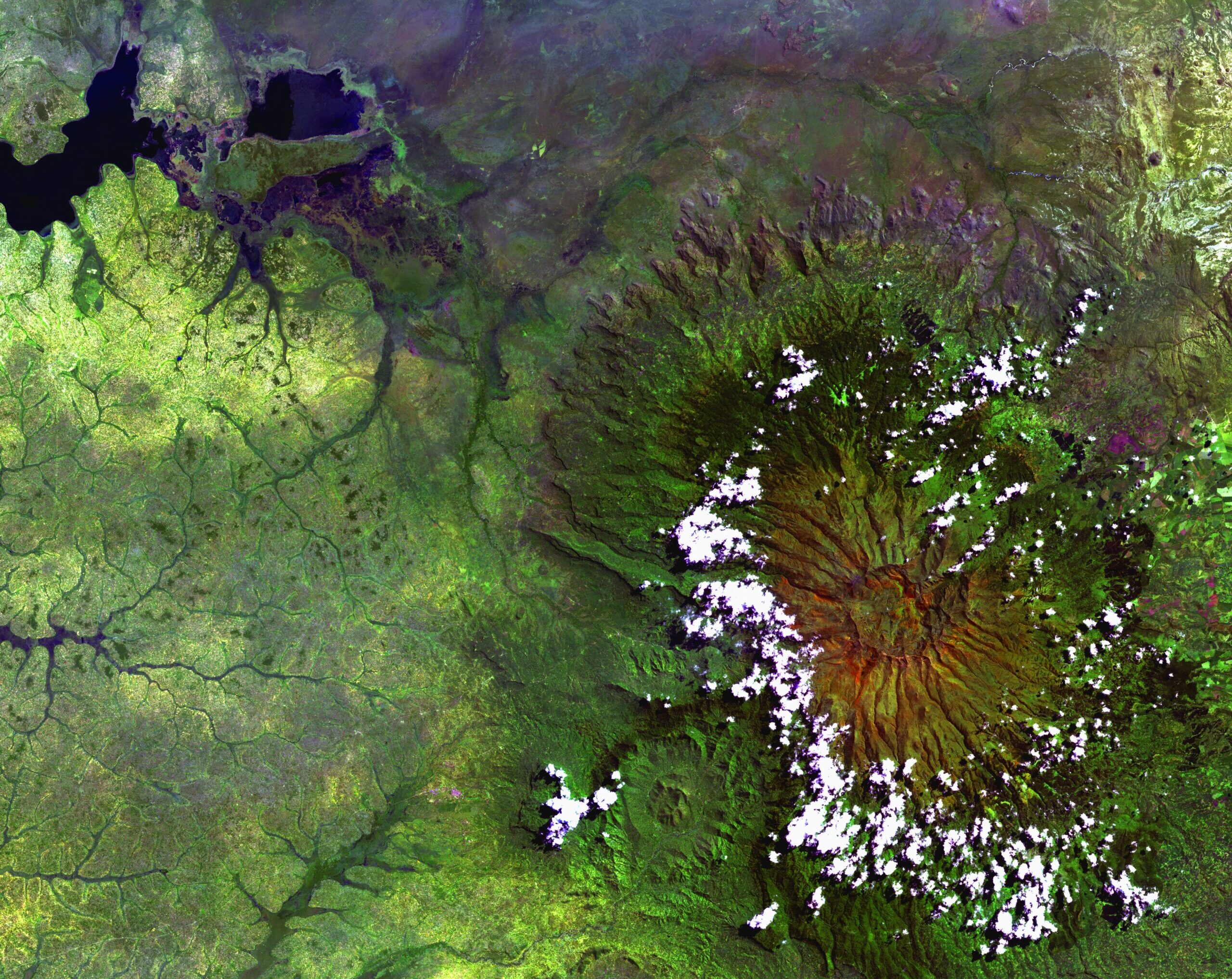 Clouds encircle the lofty rim of Africa's Mount Elgon, a huge, long-extinct volcano on the border between Uganda and Kenya.