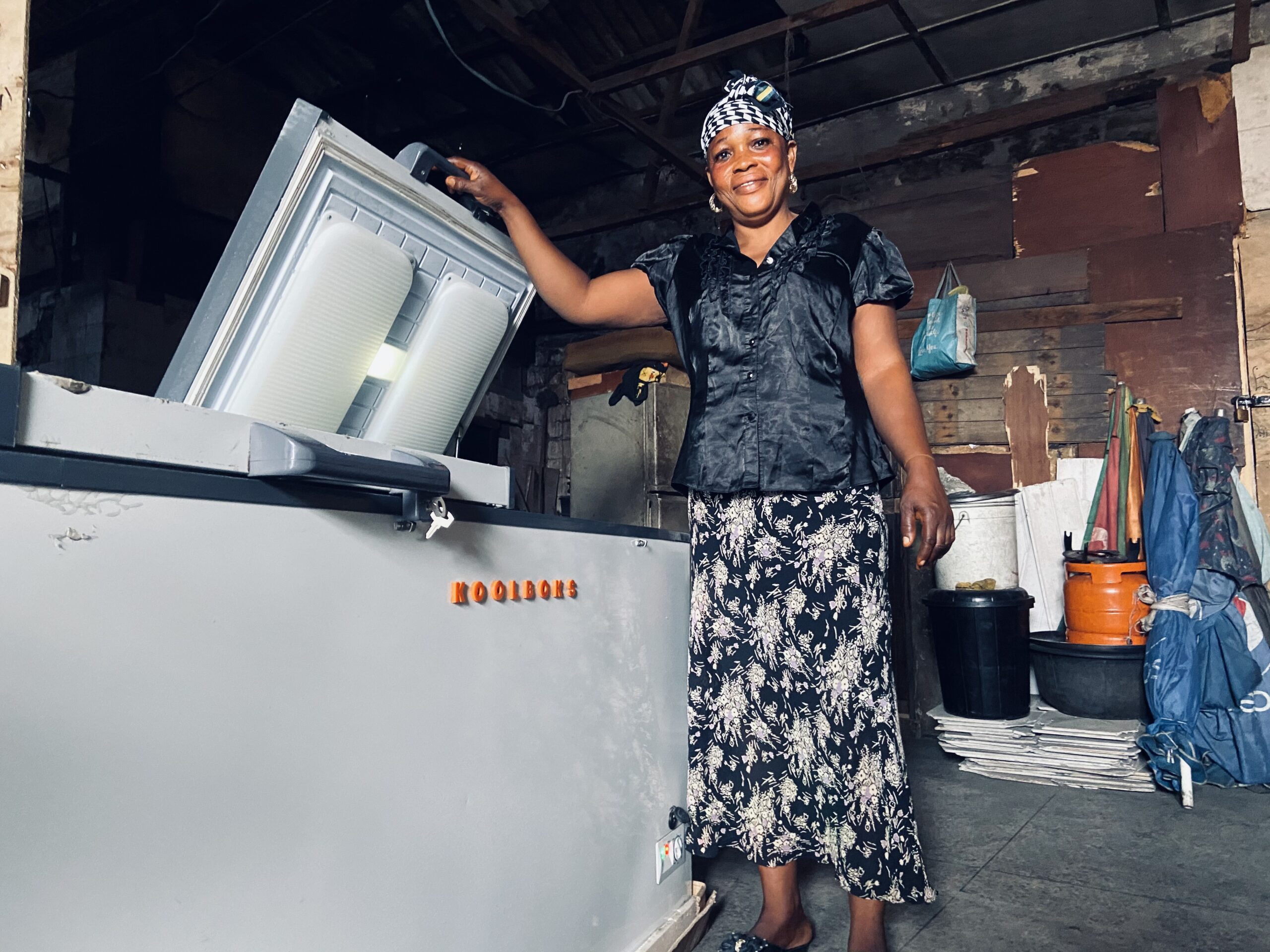 Mama Ibadan, owner of a small shop in Nigeria, uses a Koolboks solar powered refrigerator to preserve her products through power outages